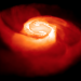 A spiral created by two neutron stars that are swirling closer and closer to each other.
