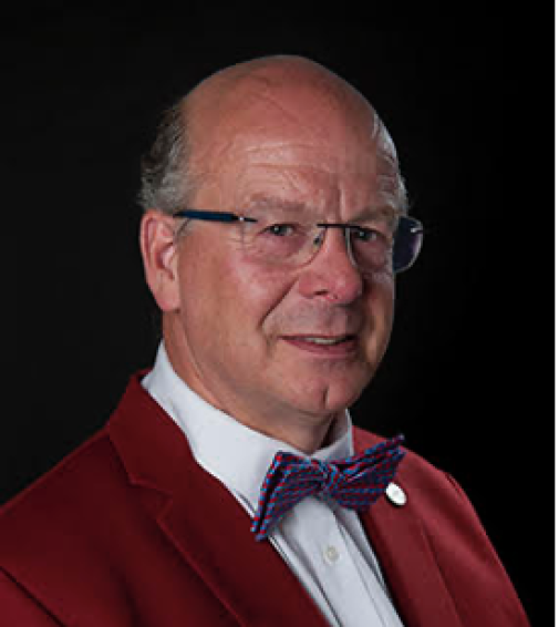 Picture of Ralph Wijers in a red sweater with a bowtie and white shirt.
