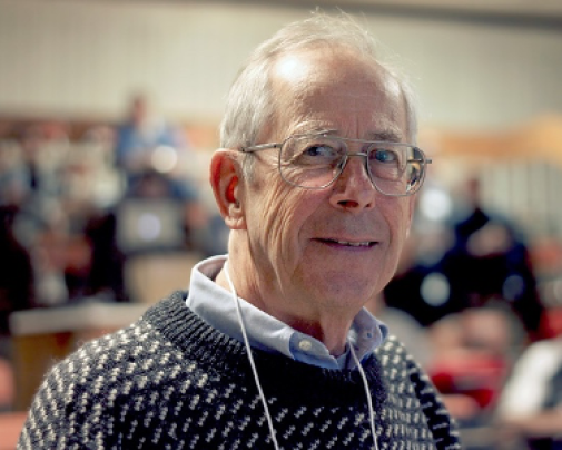 Picture of Jim Peebles in a grey sweater with white dots.