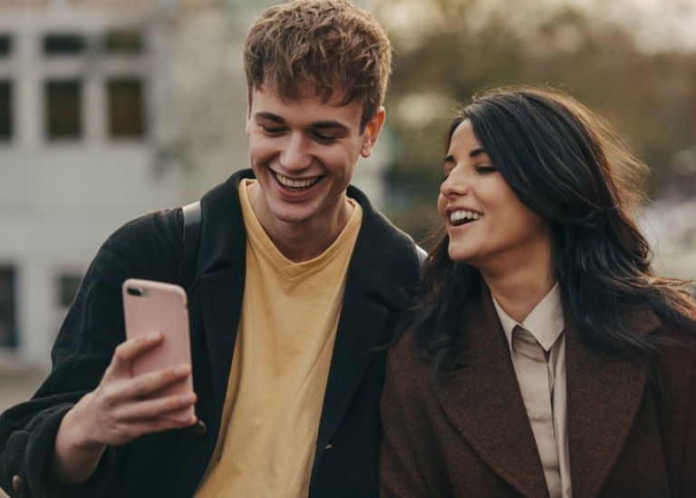 Students looking at a mobile phone.