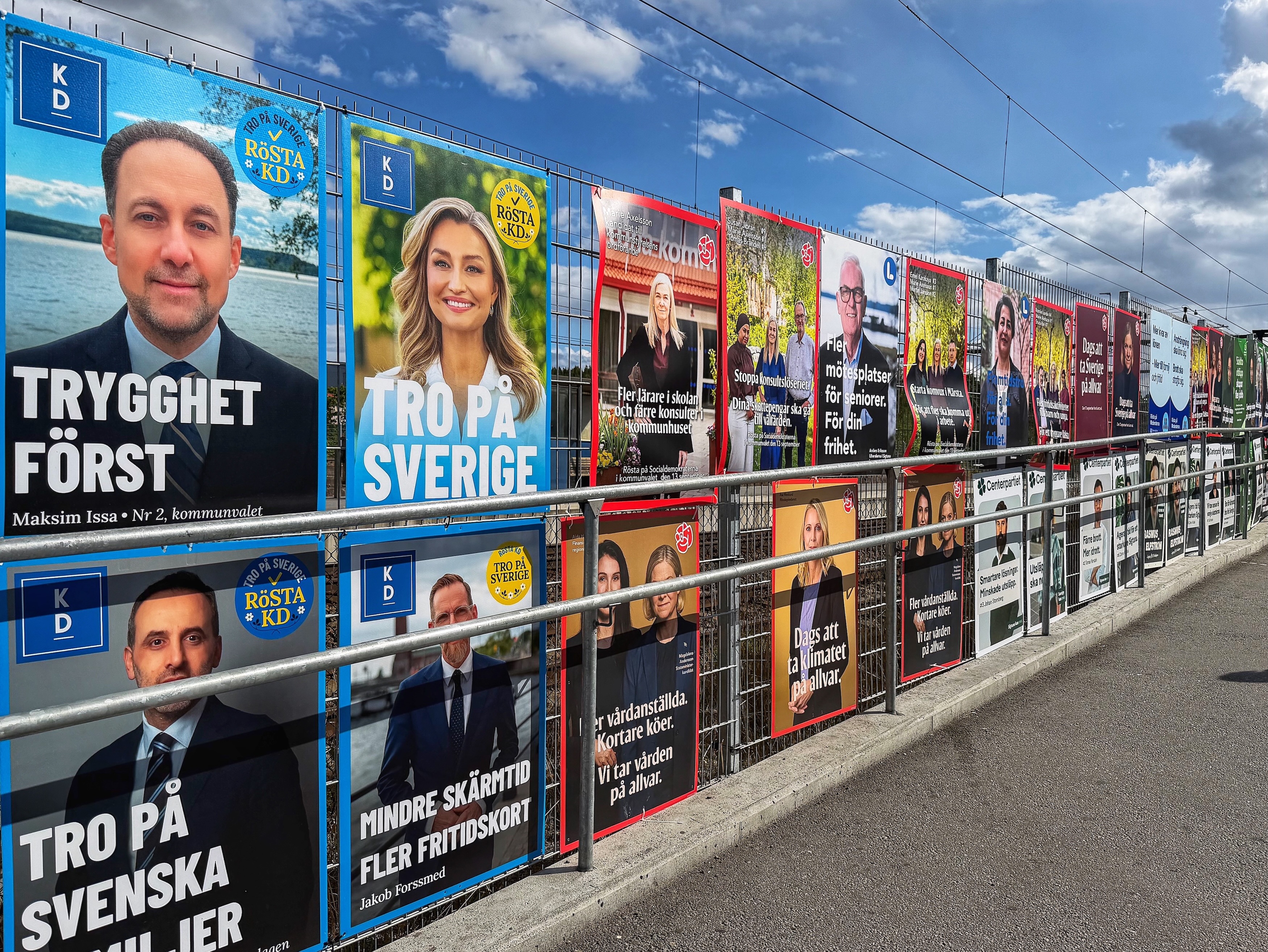 MÄRSTA, SWEDEN – AUGUST 17: A row of political election posters on a metal fence along a street on a sunny day. Photo: Krister Hägglöf/Mostphotos