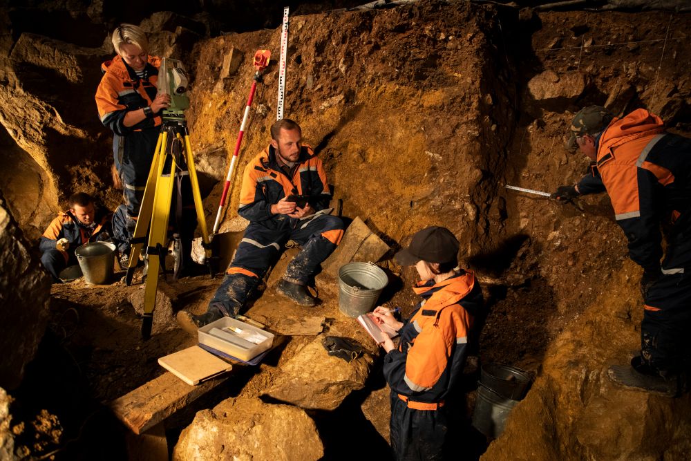 Five persons in a cave.