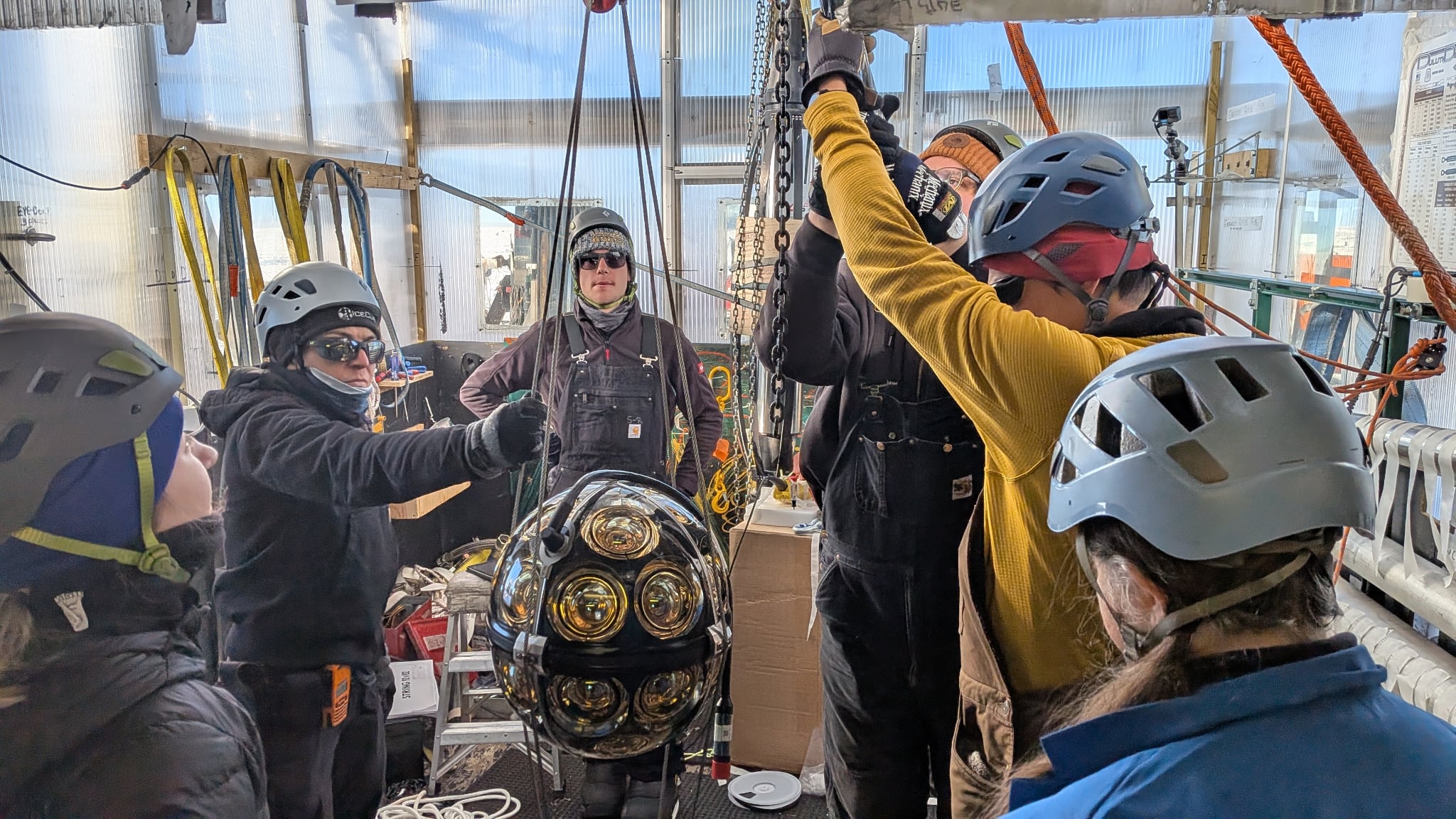 Drillers lowering one of the new sensors into a hole.