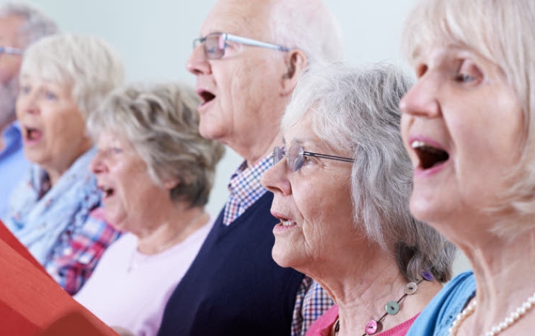 Elderly people singing in choir.