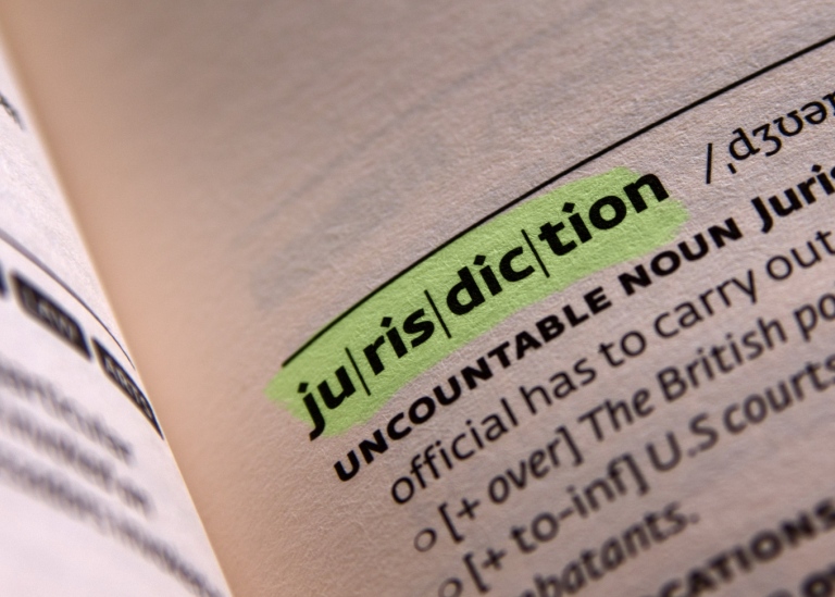 open encyclopedia with the word jurisdiction in focus