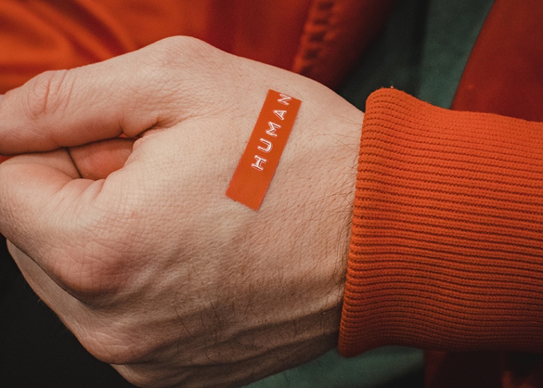 Hand with 'human' written on it