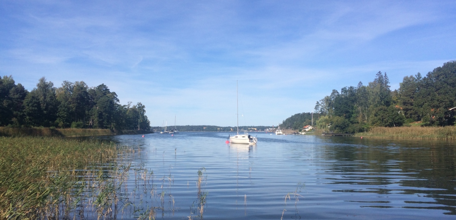 View of shallow coastal bay with a sailing boat in the horizon. Photo: Betty Gubri.
