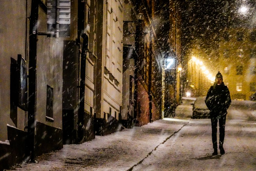 Person walking in Stockholm on a dark cold winter night.