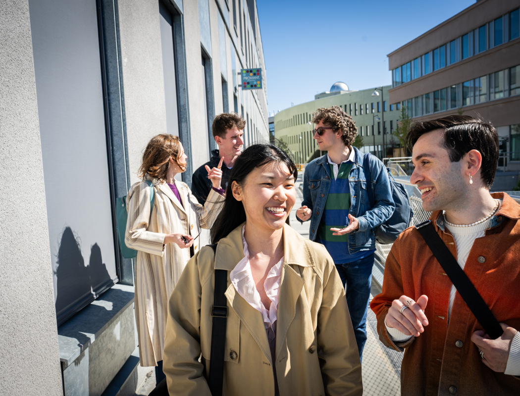 A group of people standing on the side of a building.