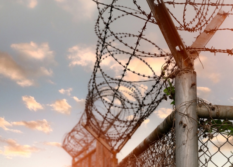 Prison fence with barbed wire