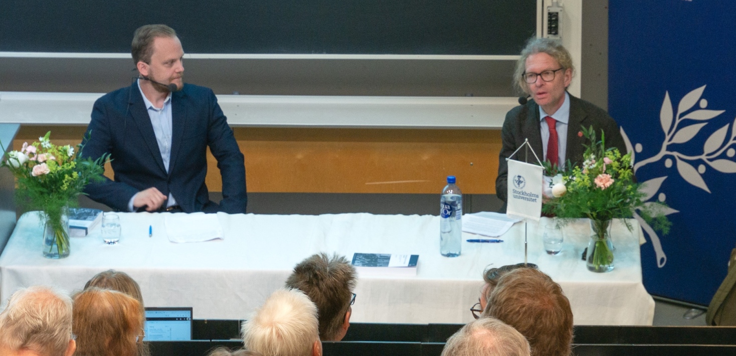Två personer sitter och diskuterar.