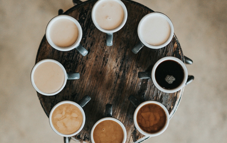A top-down view of eight coffee mugs.