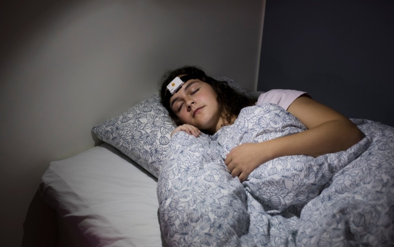 Young woman sleeping in the sleep lab.