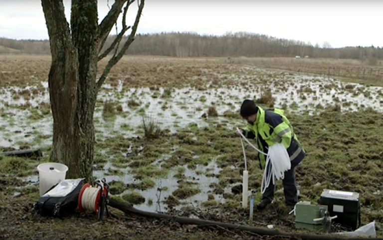 Geologist on the field taking water samples