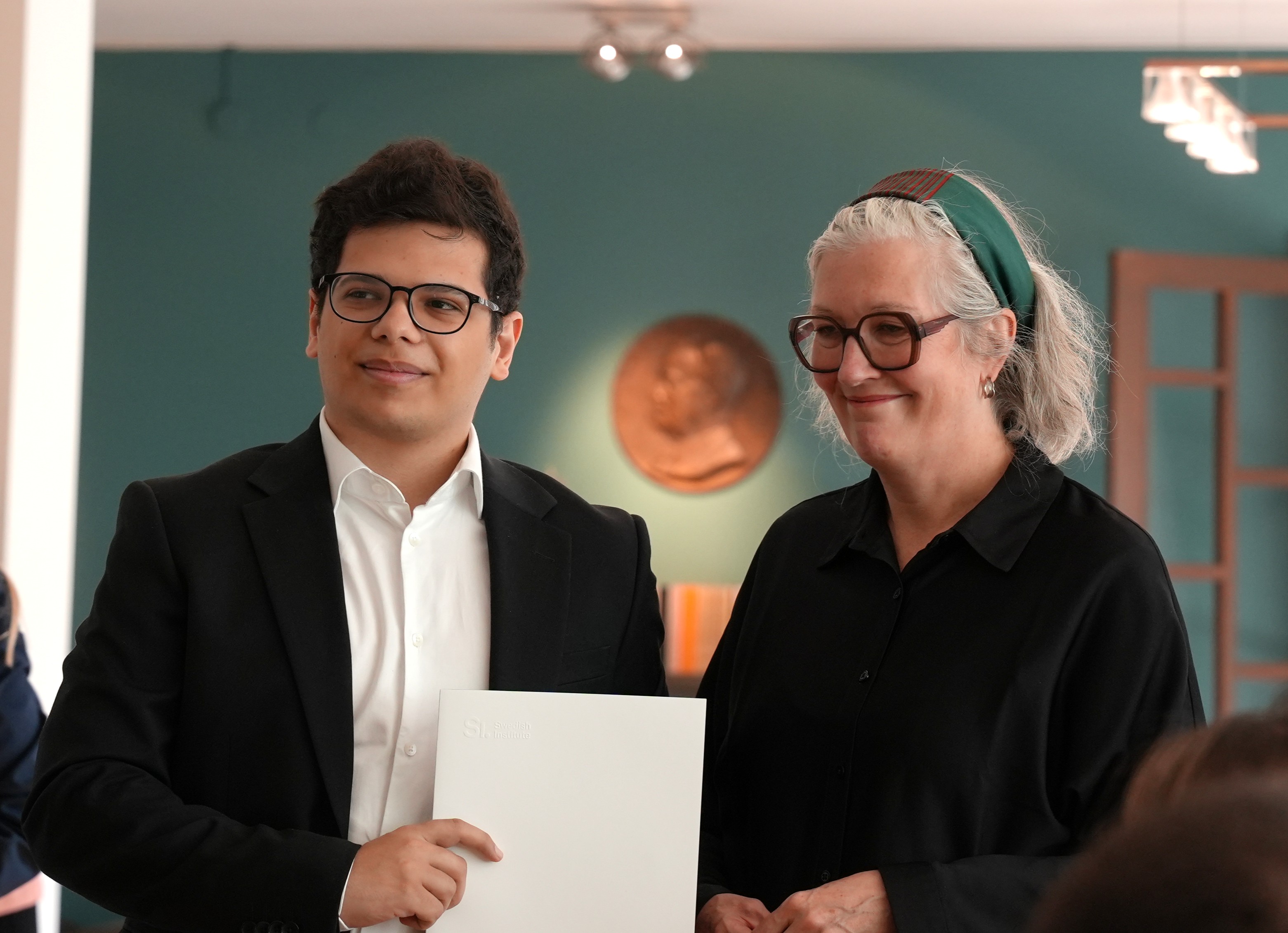 Riyad accepting his diploma.