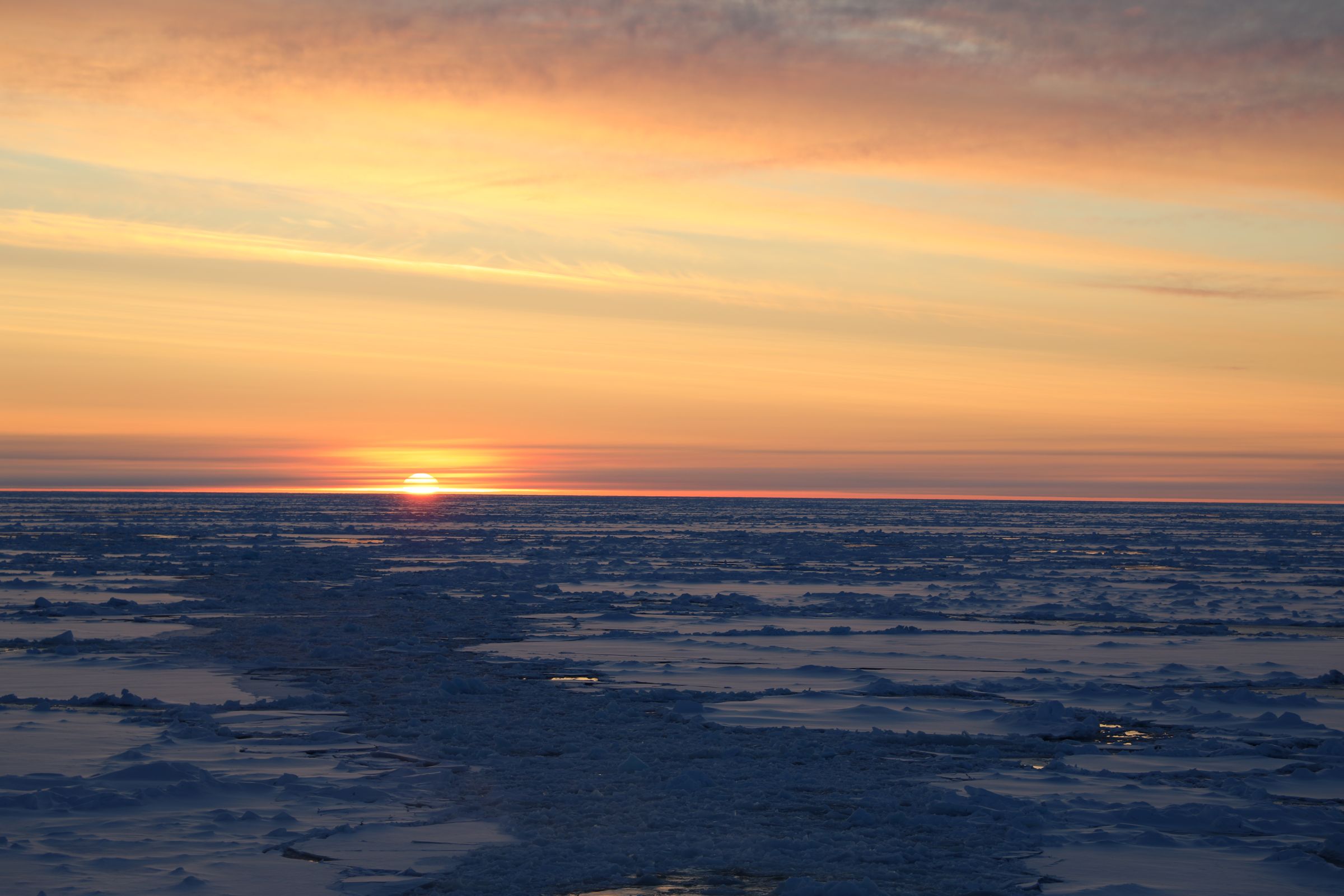 Caption: The sun sets over Arctic sea ice on 12 September.