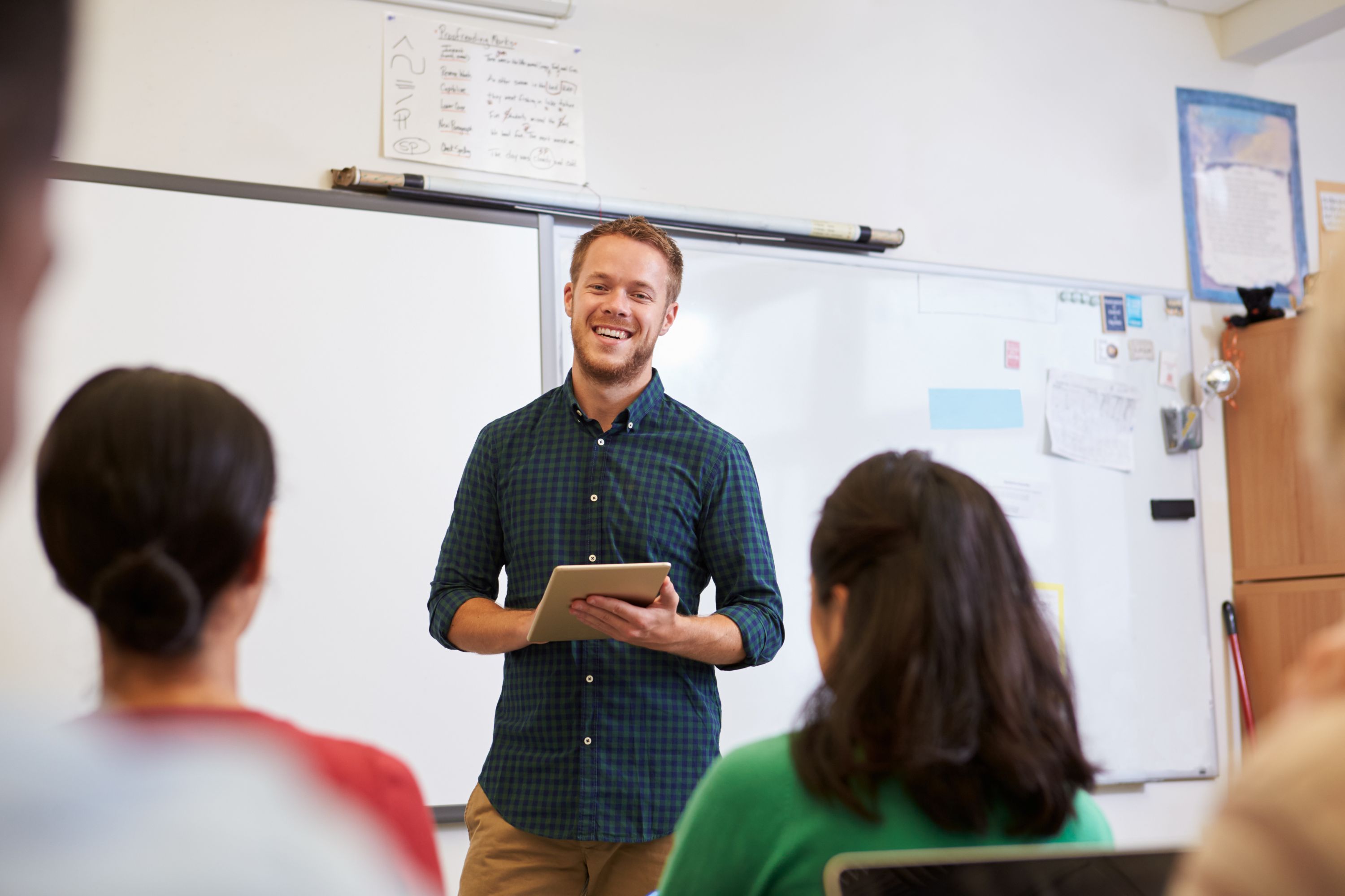 Young man in front of class.