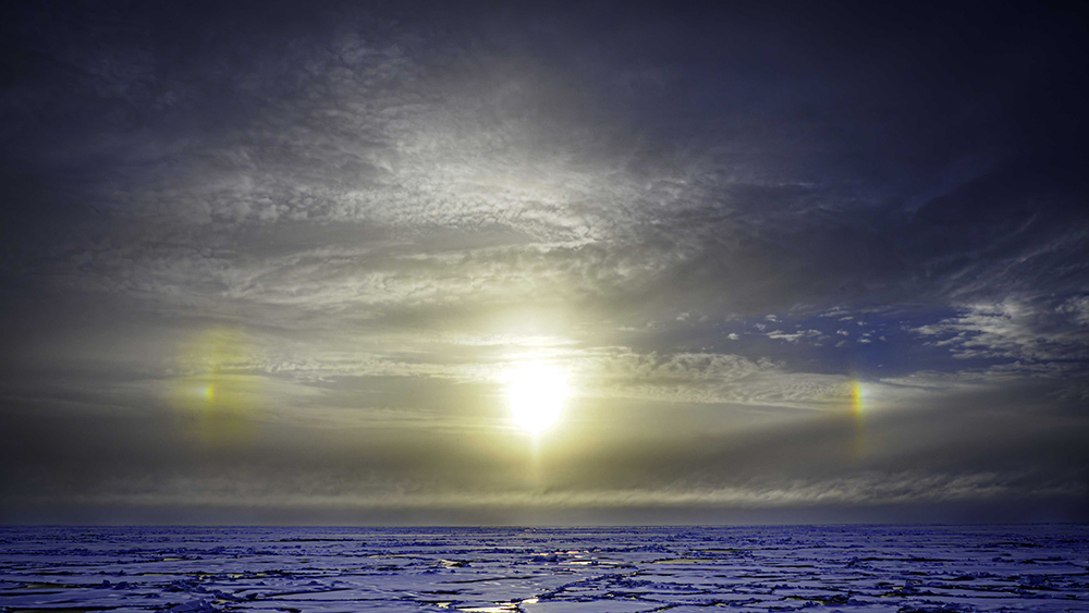 The sun bisolars, the sky, the ocean.