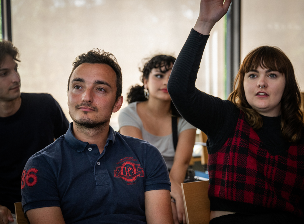 A student raises her hand.