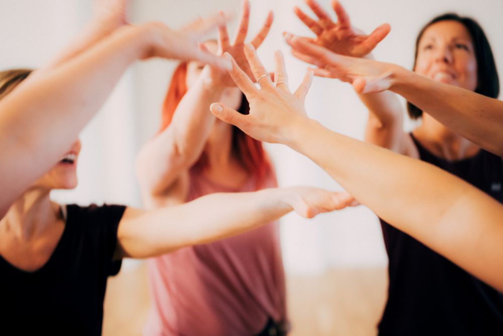 Students participating in Dance for Health. Holding up hands in the air.