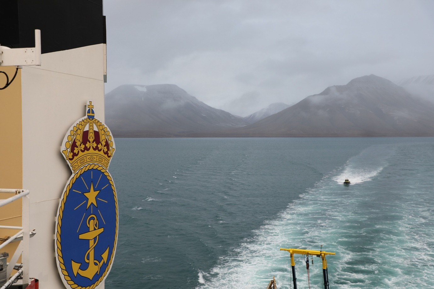 Image 3: A view of the mountains of Svalbard as we head out to sea; the last land we will see in weeks.
