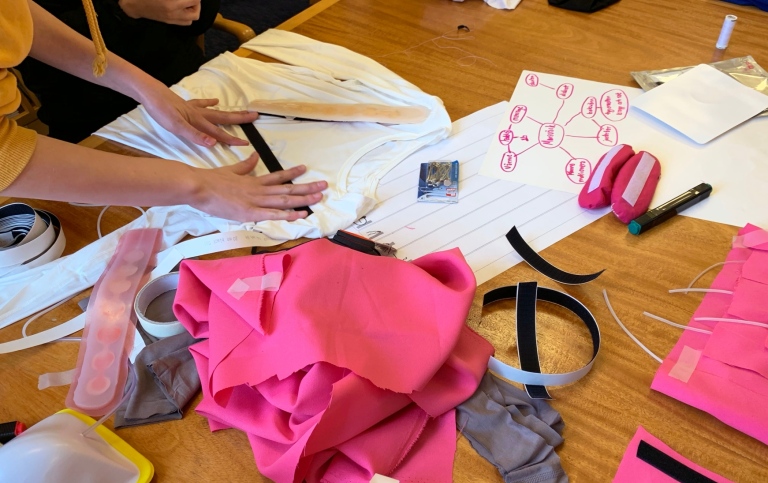 People around a table with workshop material about trust and contraceptive methods.