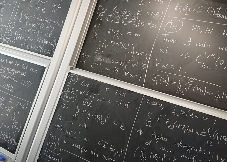 Blackboard with mathematical formulas in chalk.