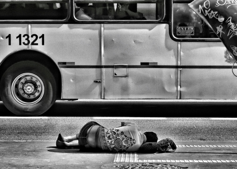 person sleeping on the sidewalk