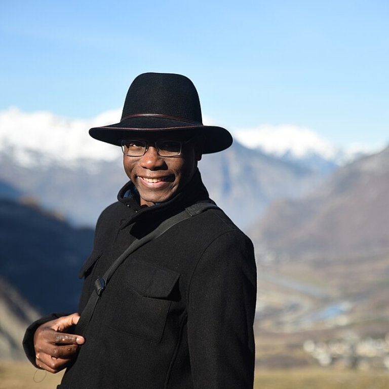 Buata Malela, associate-professor, posing in the middle of the Alps in December, full winter.
