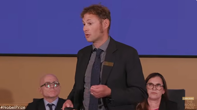 Timo Boppart presenting the work of the 2026 laureates at the Nobel announcement.
