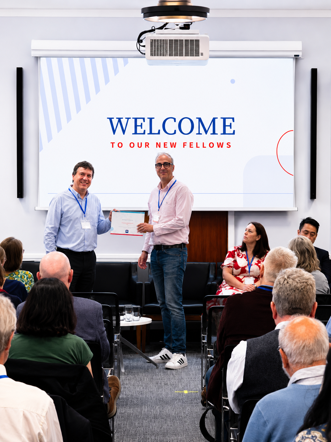 Professor Giles Whiteley is welcomed as a fellow by professor David Duff.