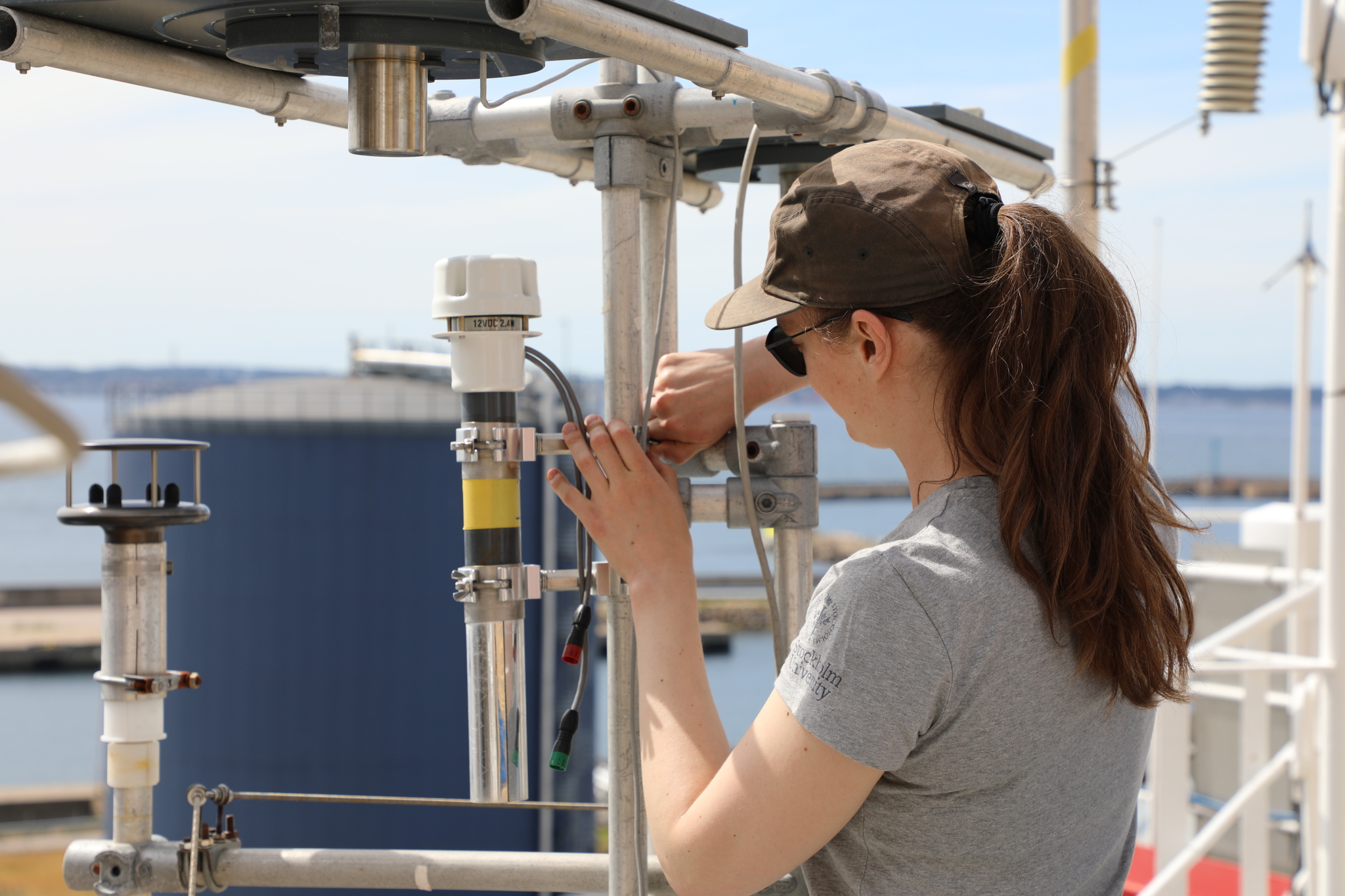 Image: Linnea installing a sensor to measure temperature and moisture on top of I/B Oden.