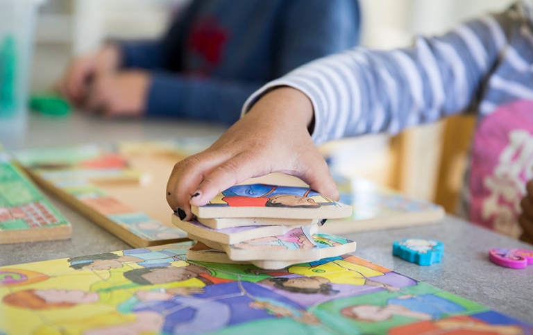 Child laying a puzzle