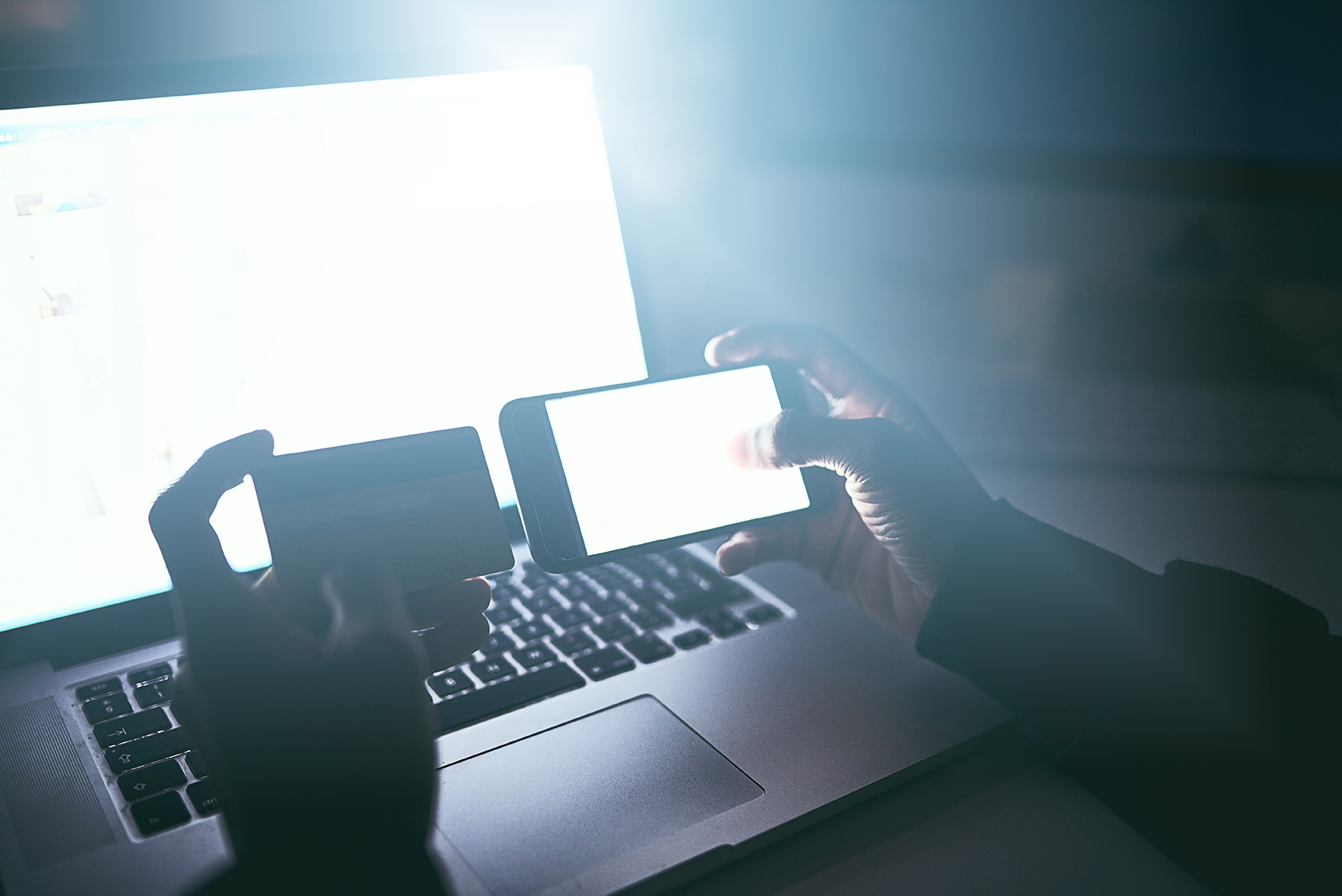 Hands, credit card and phone on laptop for online gambling payment.