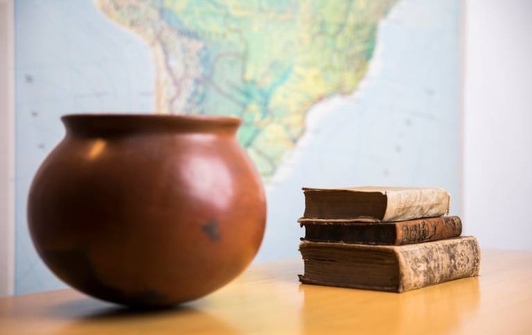 Book, jar and map in background
