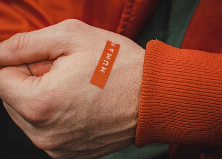 Hand with 'human' written on it