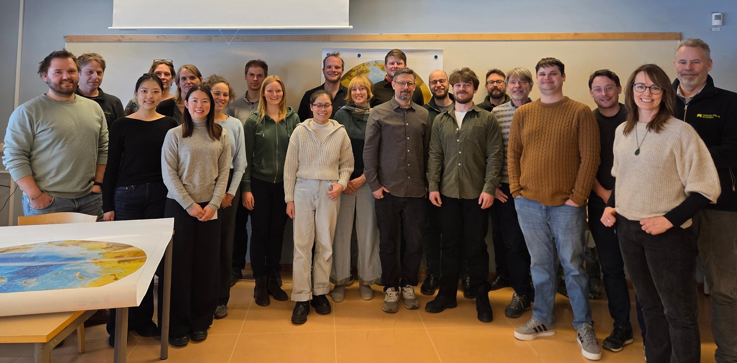 Group of 22 researchers standing in a meeting room for a group picture.