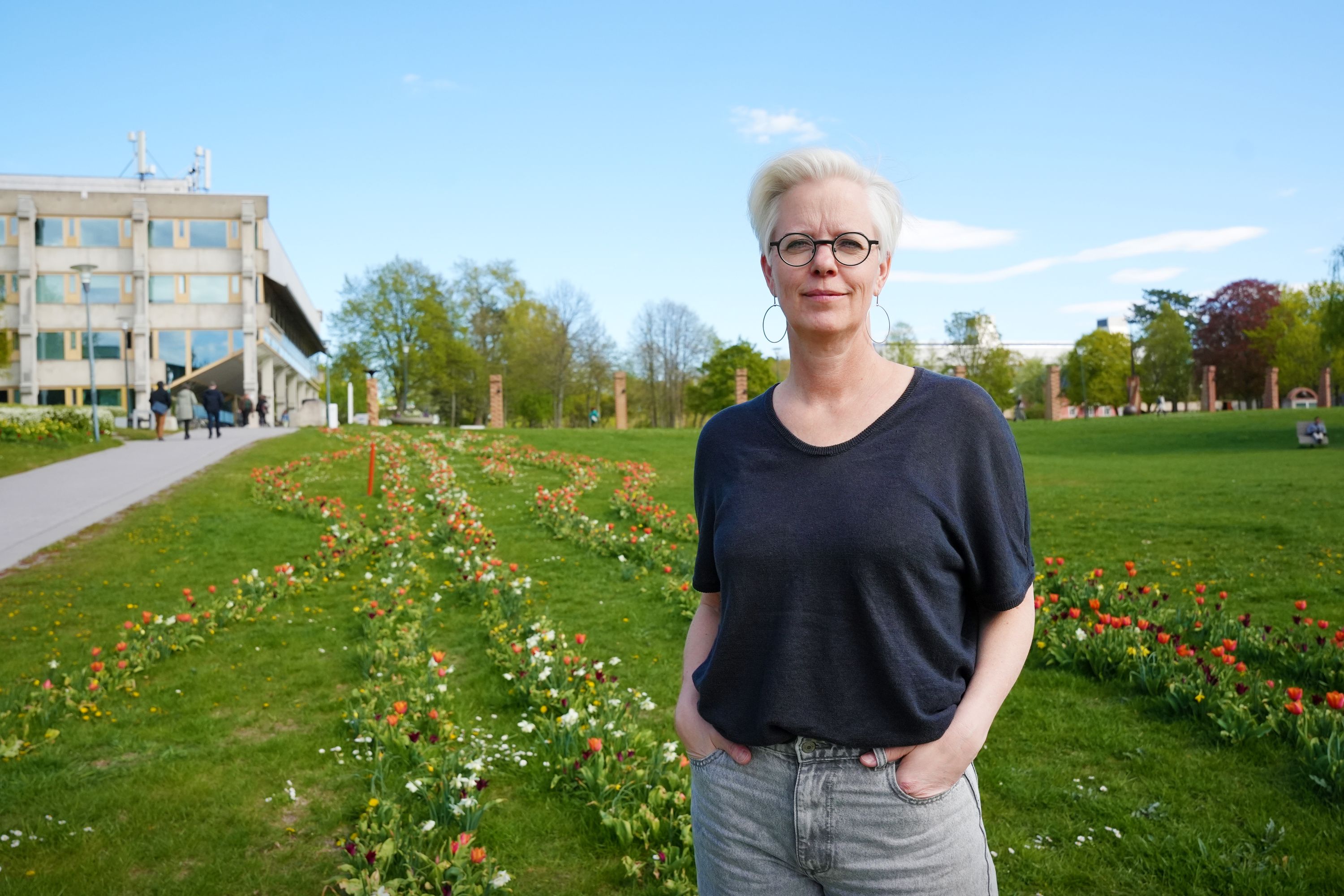woman looking at the camera in a field of flowers