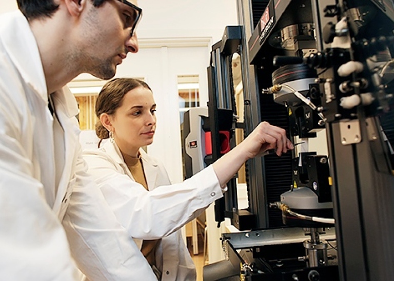 Natalia and Konstatin in front of an instrument.
