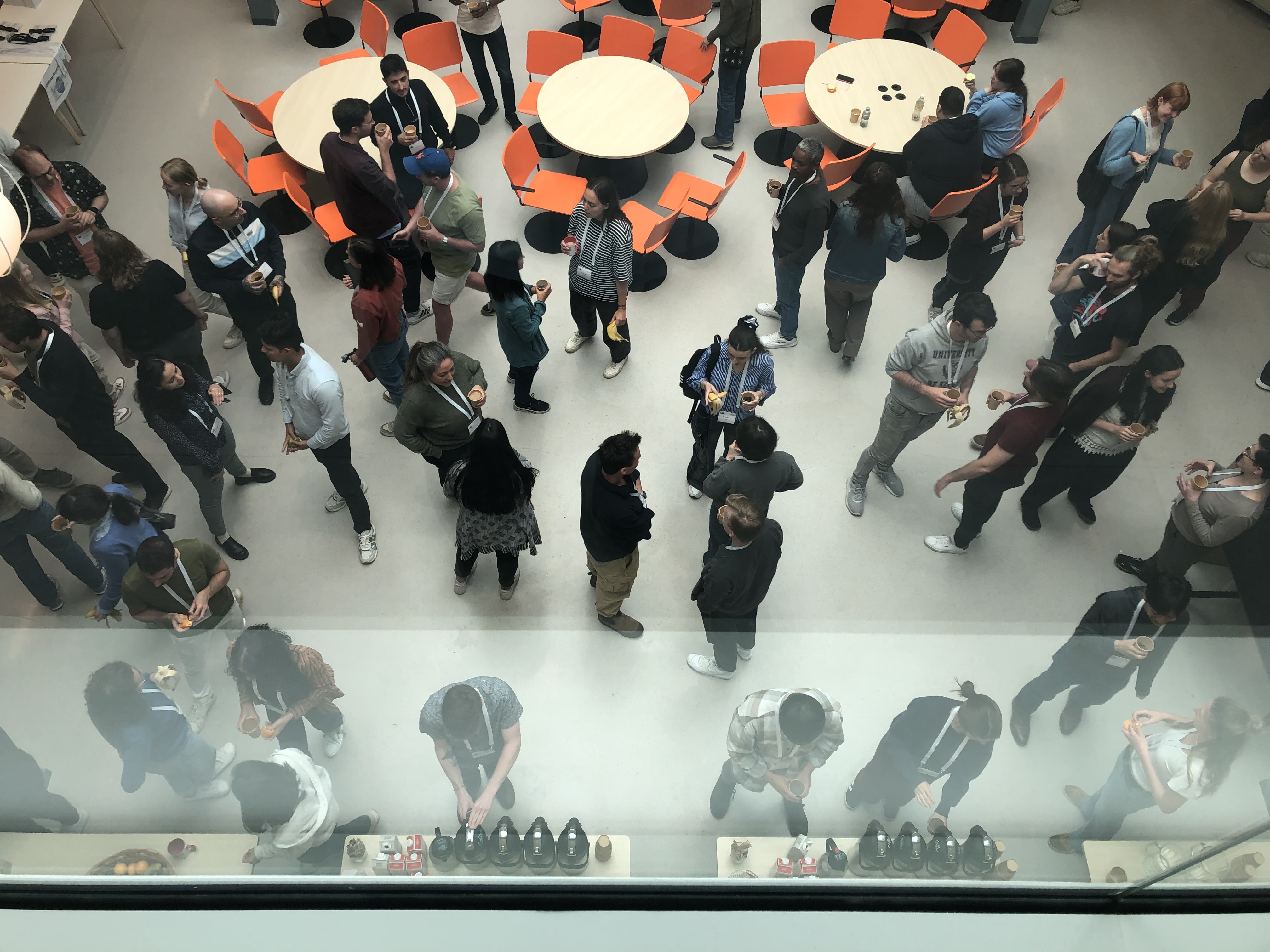 Indoor scene from above, people standing and talking in groups