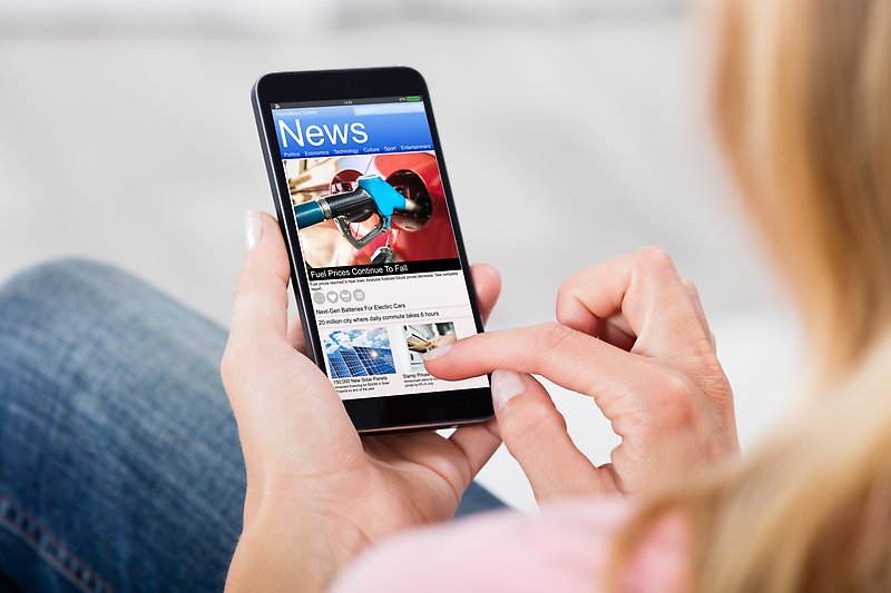 woman reading news on mobile phone