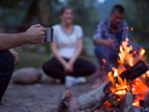 Students sitting around a campfire.
