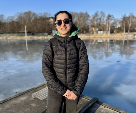 Ilana standing by an ice hole after a winter swim, saying she normally avoids cold water but still jumped in.