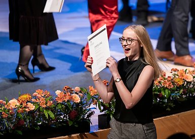 Happy student with diploma.