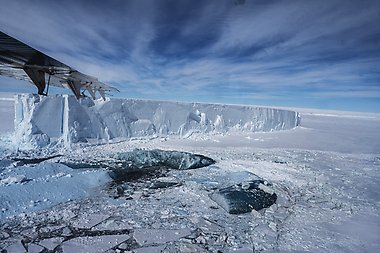 The edge of a large ice shelf in Antarctica. The photo is taken from a small airplane