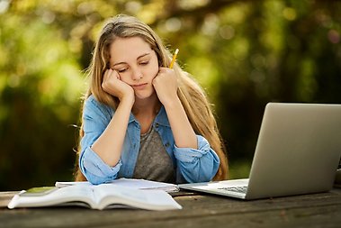 Female student looking tired and stressed.