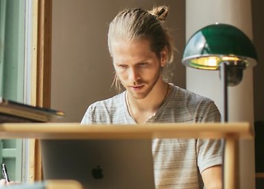 Male student working on a laptop