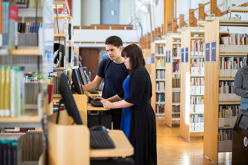 Student and teacher at library.