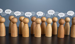 Wooden figures and speech bubbles.