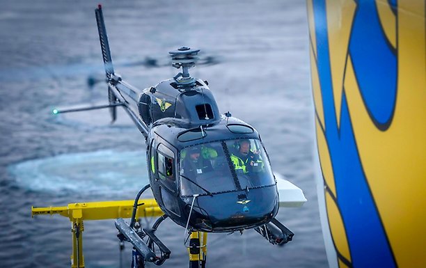 Helicopter landing on deck. A water "bubble" in the background.